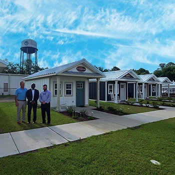 Finklea, Hendrick, and Blake Standing with Tiny Homes